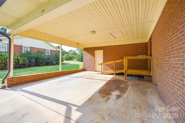 a view of a room with wooden floor and fence