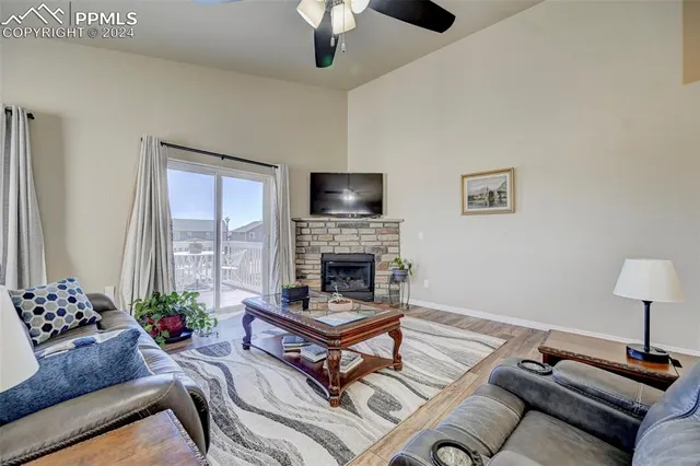 a view of a hallway with wooden floor and stairs