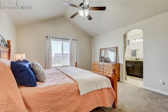 a bathroom with a granite countertop bathtub a sink and a large mirror