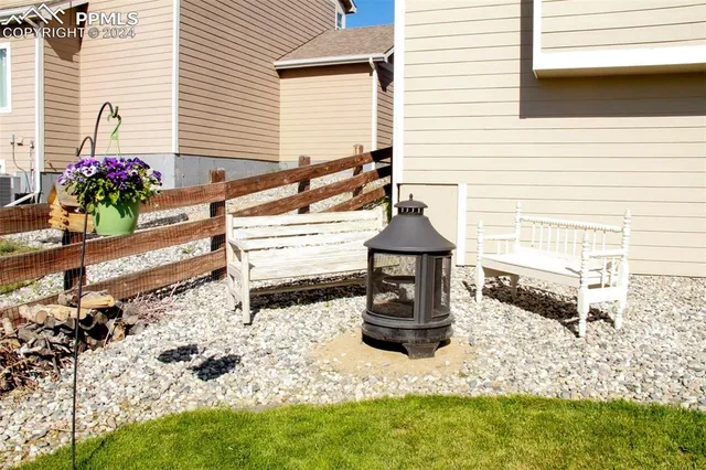 a view of a swimming pool with a yard and plants