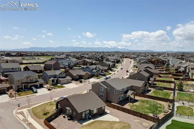 a view of a house with yard and sitting area