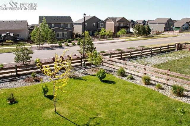 a view of a field with houses in background