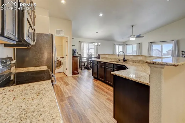 a kitchen with a stove top oven sink and cabinets