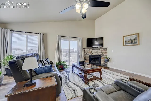a living room with furniture a fireplace and a flat screen tv