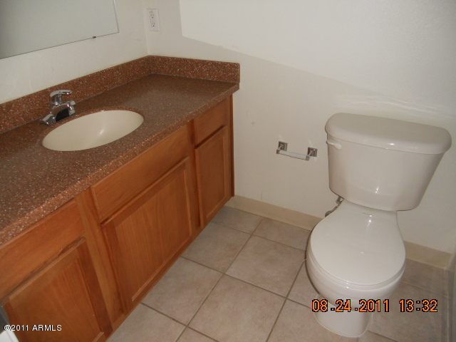 424 West Brown Road, Unit 106 Mesa, AZ 85201 - Photo 7 of 17 a bathroom with a toilet and a sink
