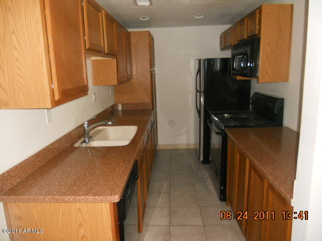 424 West Brown Road, Unit 106 Mesa, AZ 85201 - Photo 8 of 17 a kitchen with a refrigerator sink and stove