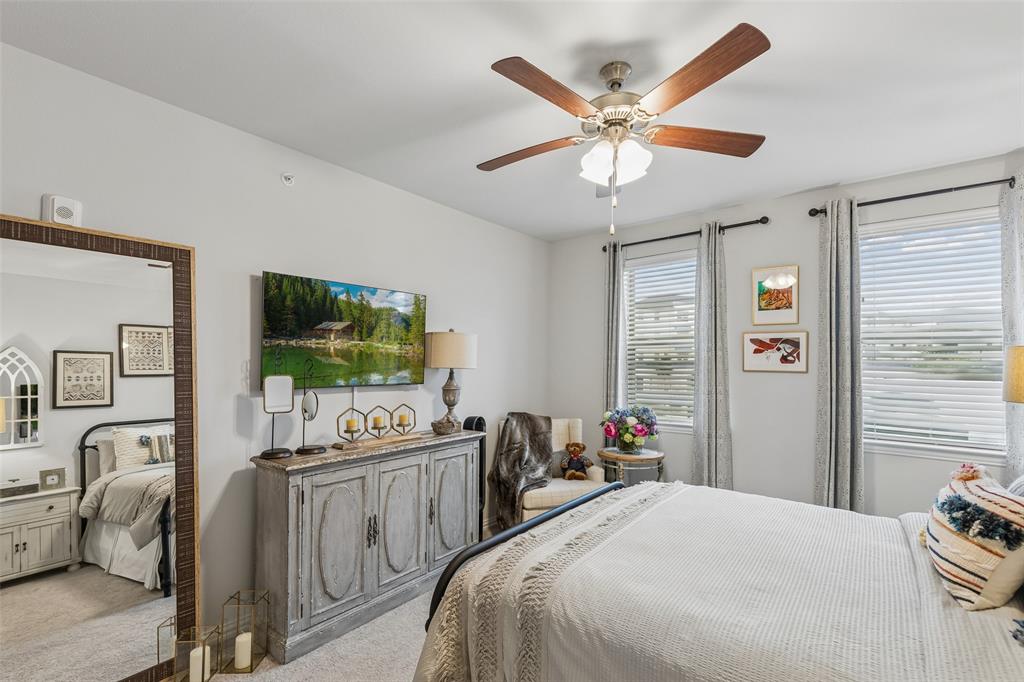 651 Watters Road, Unit 7204 Allen, TX 75013 - Photo 26 of 40 a bedroom with furniture and a flat screen tv