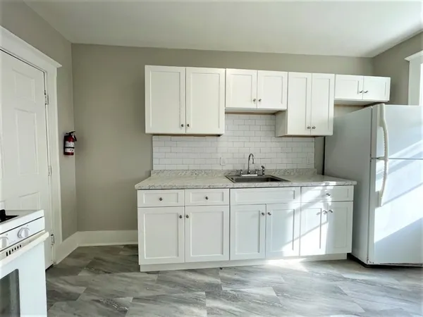 a kitchen with stainless steel appliances granite countertop a refrigerator sink and cabinets