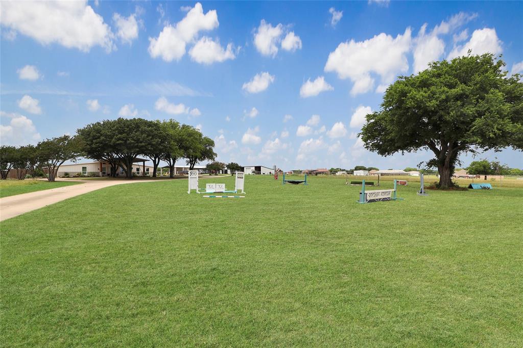 2408 Strader Road DISH, TX 76247 - Photo 1 of 40 Expansive green pasture featuring mature trees and a gravel driveway