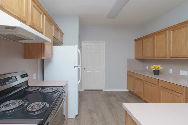 a kitchen with a stove and a refrigerator