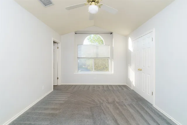 an empty room with windows and closet