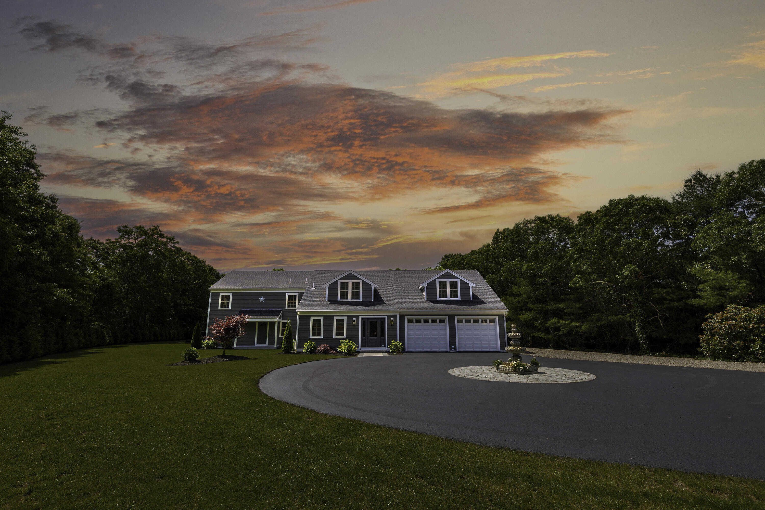 a view of a house with pool and trees in the background