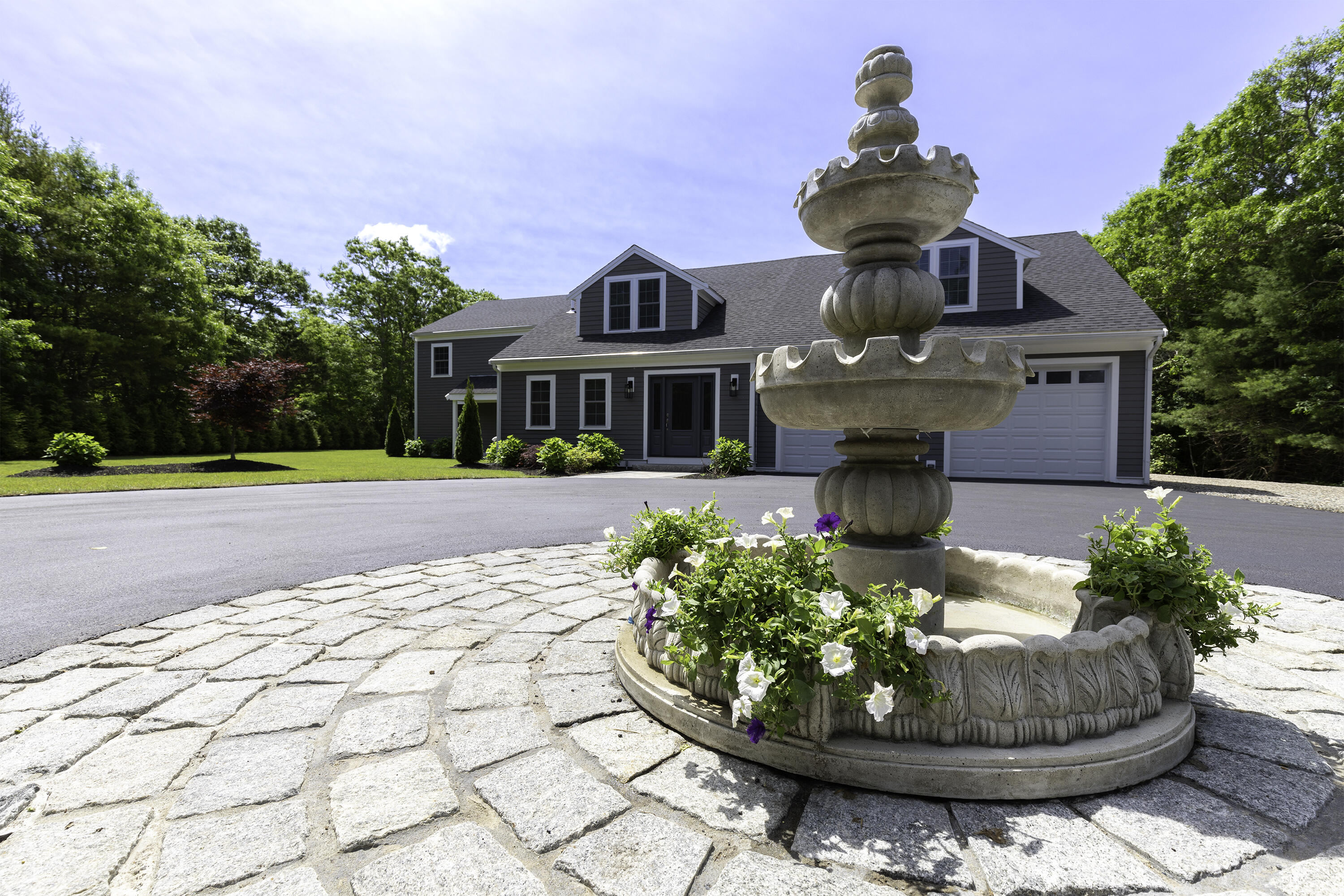 52 Boardley Road Sandwich, MA 02563 - Photo 16 of 100 a front view of a house with a yard and potted plants