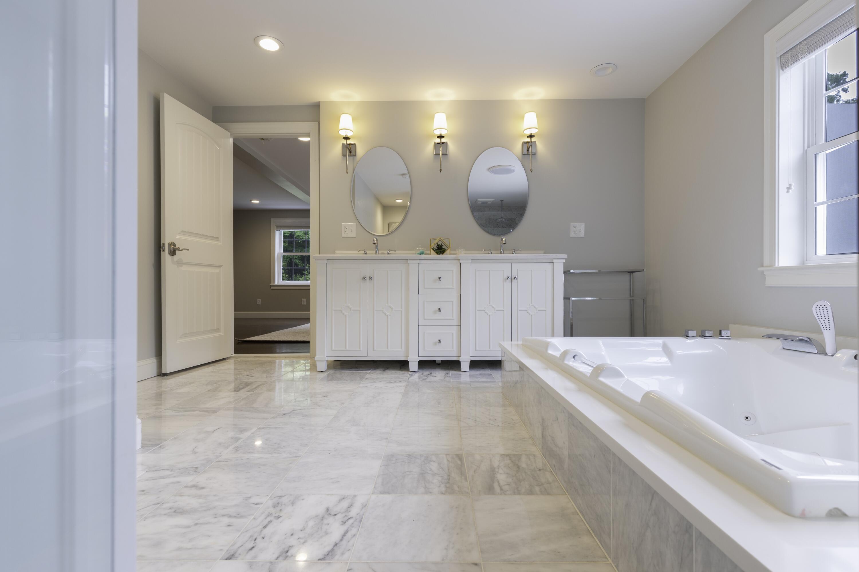 52 Boardley Road Sandwich, MA 02563 - Photo 54 of 100 a spacious bathroom with a bathtub sink and mirror