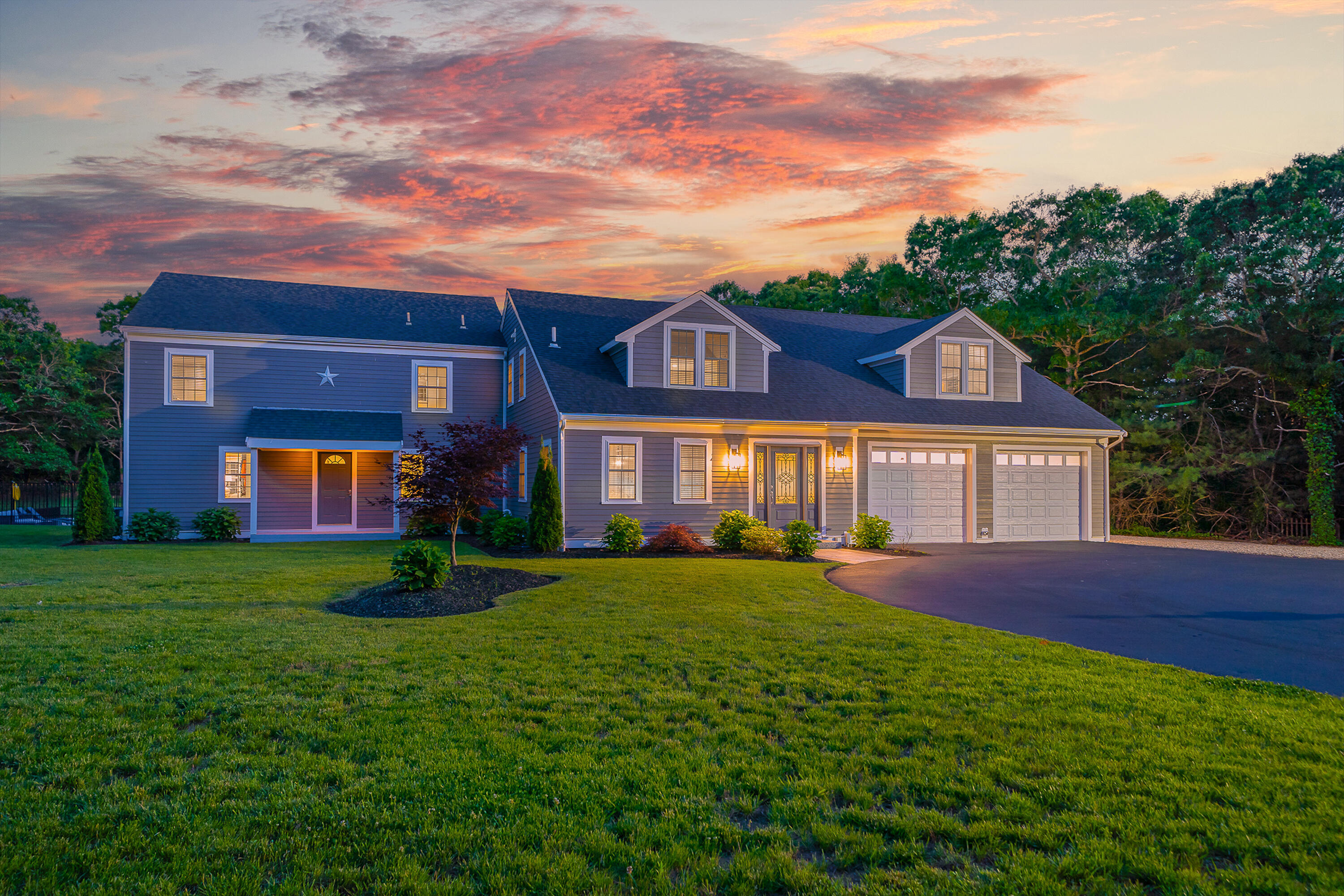 52 Boardley Road Sandwich, MA 02563 - Photo 97 of 100 a front view of a house with a yard and trees