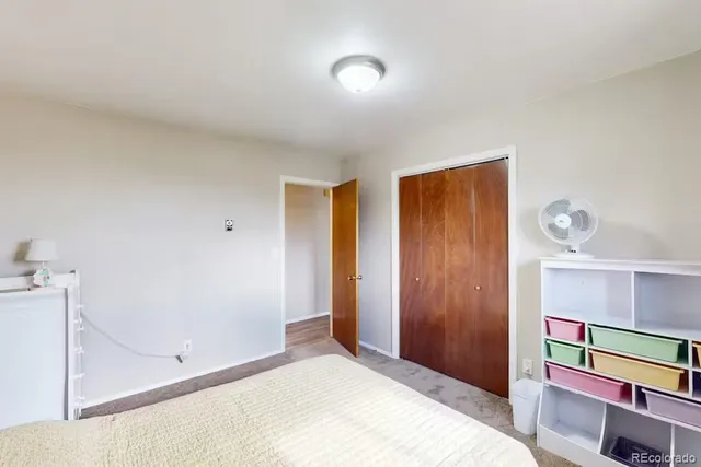 a bedroom with a bed and a painting on the wall