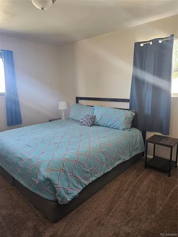 a bedroom with a bed and a night stand