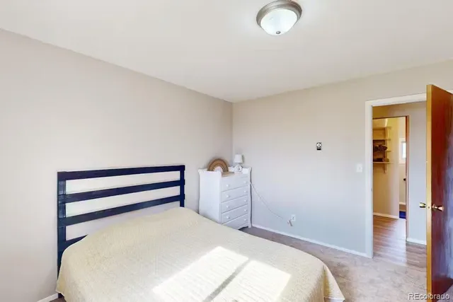 a bedroom with a bed and a lamp on the table