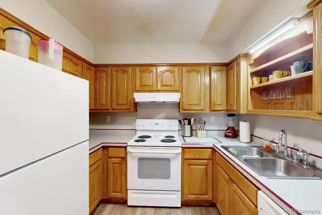 a kitchen with stainless steel appliances a stove a sink and a refrigerator