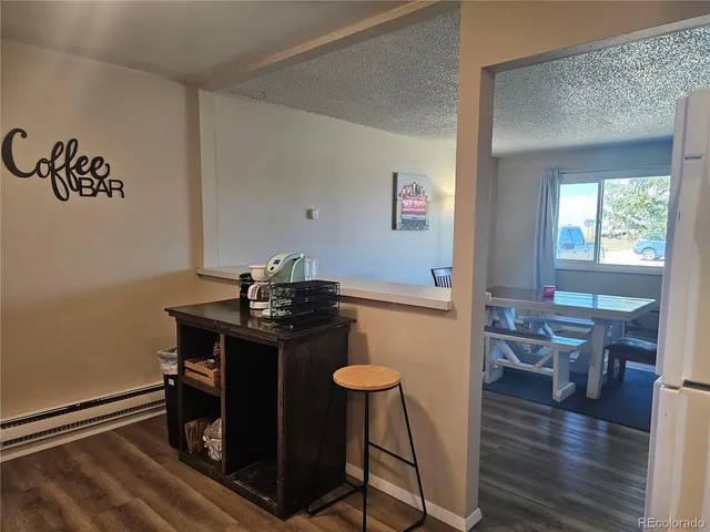 a view of a dining room with furniture and wooden floor