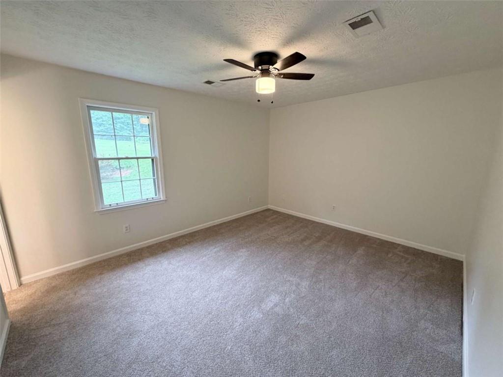 185 Roberts Road Covington, GA 30016 - Photo 18 of 25 an empty room with a window and a fan