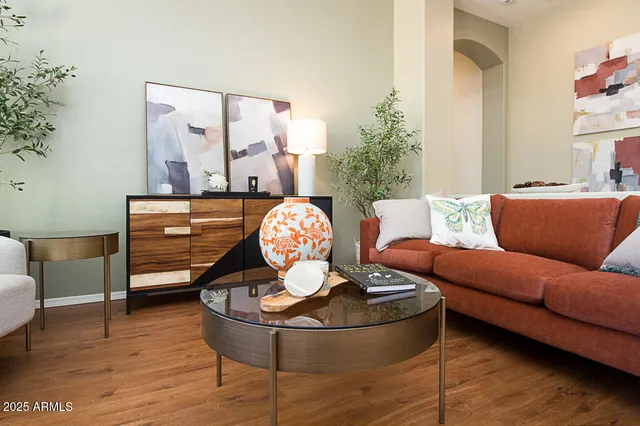 a living room with furniture and wooden floor