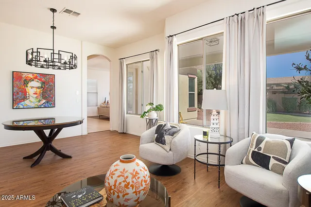 a living room with furniture and a chandelier