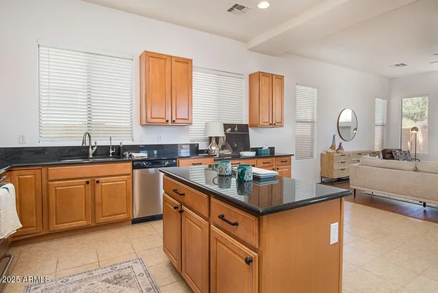a kitchen with stainless steel appliances granite countertop a sink stove and cabinets