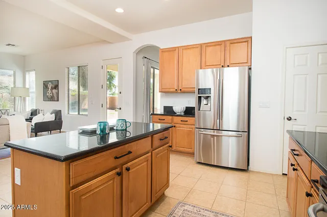 a kitchen with appliances a sink and a refrigerator