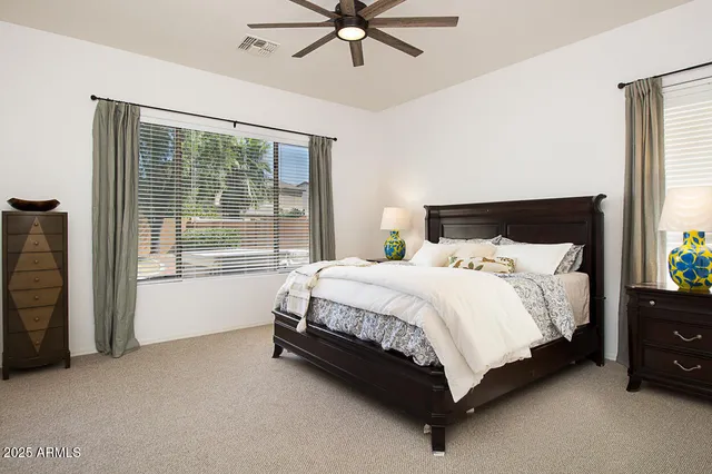 a bed sitting in a bedroom next to a window