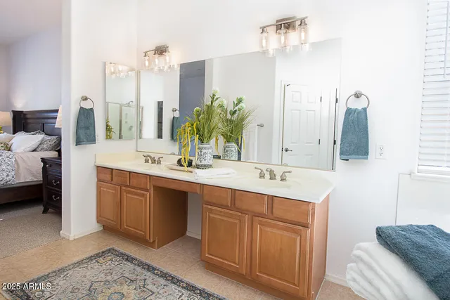 a bathroom with a double vanity sink and a mirror