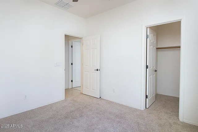 an empty room with closet area