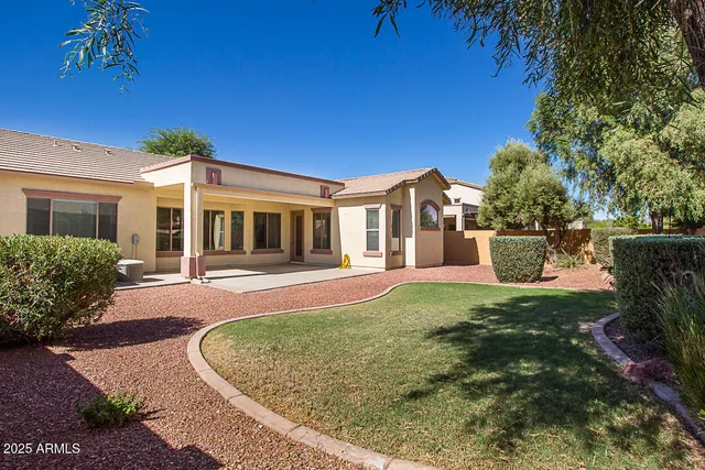 a view of a house with a tree in the yard