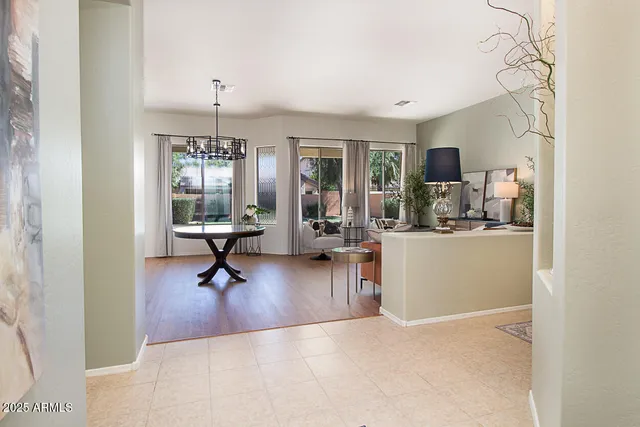 a view of a livingroom with workspace and a window