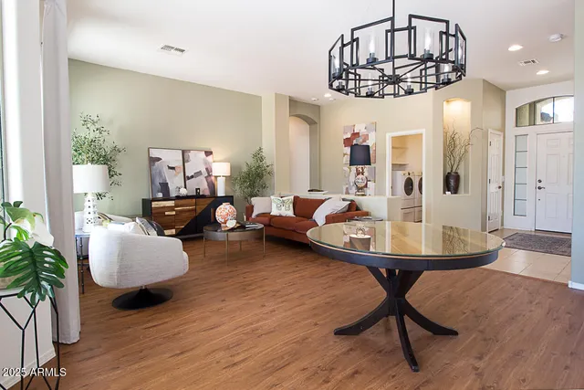 a living room with furniture and a chandelier