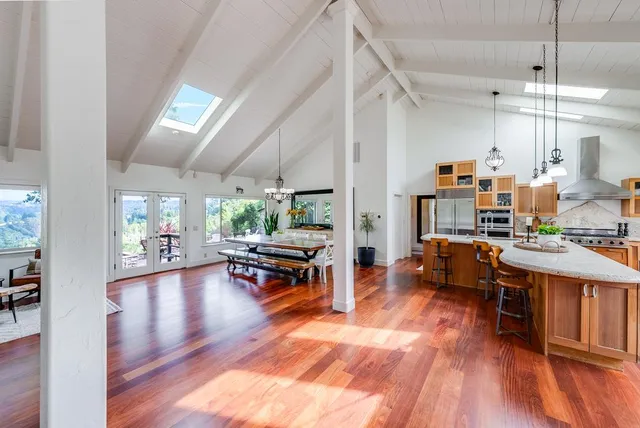 a view of a dining room with furniture a chandelier and wooden floor