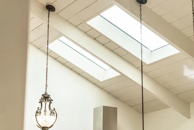 a vase of flowers sitting on a table with window