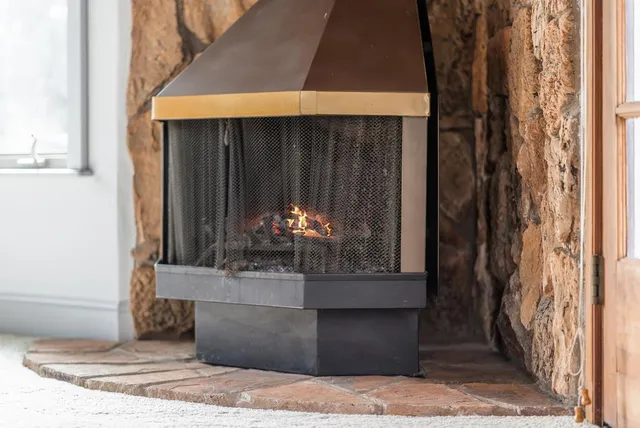 a spacious bedroom with a large bed a chandelier and windows