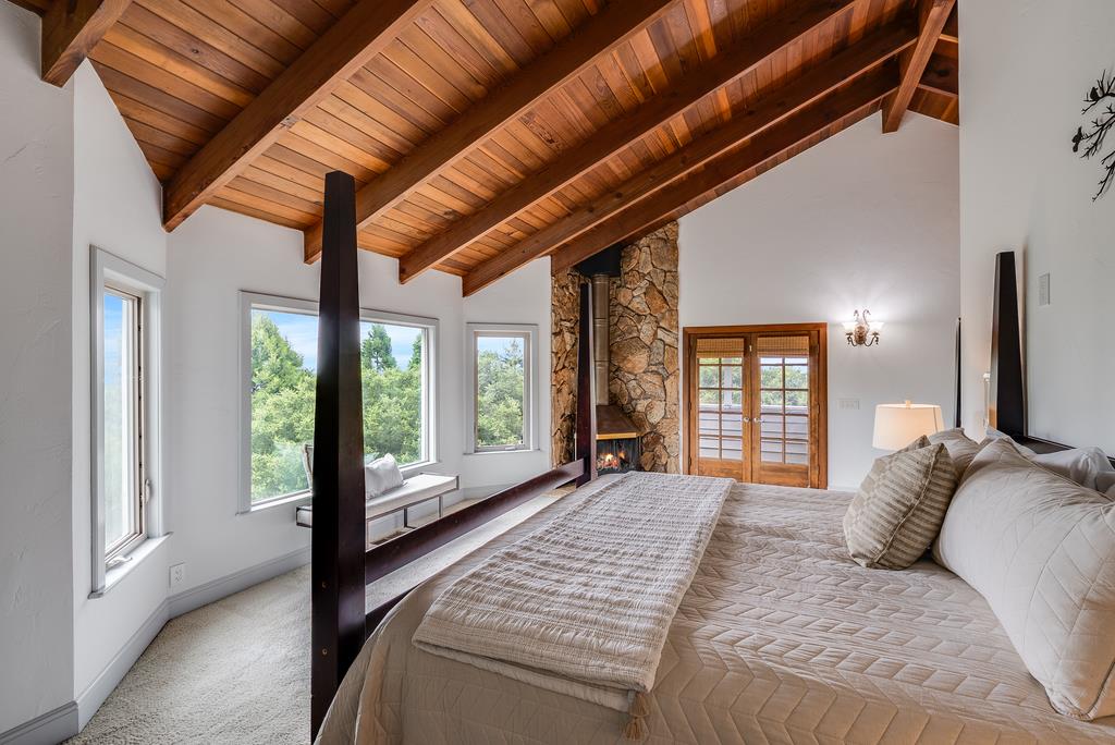 1501 Hidden Valley Road Soquel, CA 95073 - Photo 22 of 61 a bedroom with a large bed and a large window with outer view