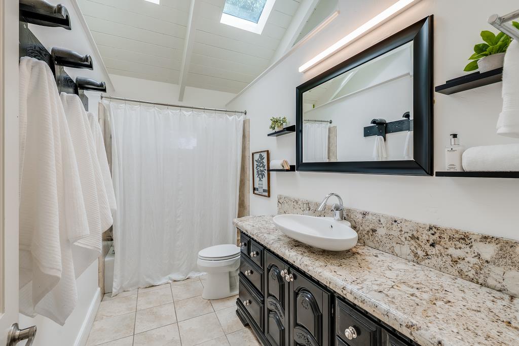 1501 Hidden Valley Road Soquel, CA 95073 - Photo 36 of 61 a bathroom with a granite countertop sink and a mirror