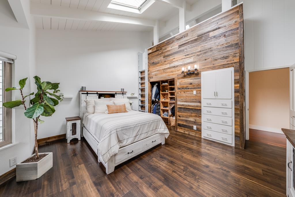 1501 Hidden Valley Road Soquel, CA 95073 - Photo 38 of 61 a bedroom with a bed table and a potted plant