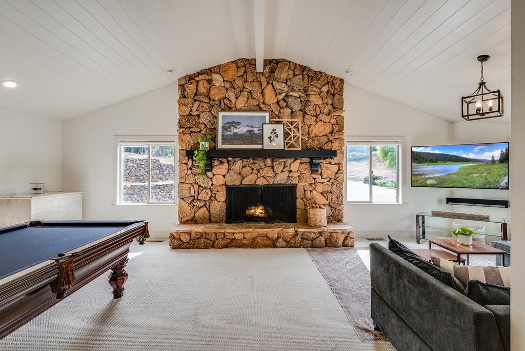1501 Hidden Valley Road Soquel, CA 95073 - Photo 41 of 61 a living room with furniture a flat screen tv and a fireplace