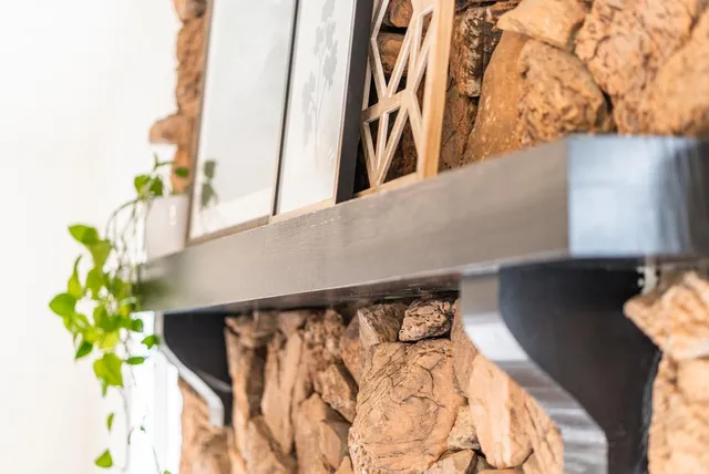 a bedroom with a large bed a chandelier and windows