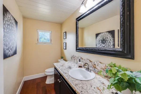 a view of a patio with table and chairs and wooden fence