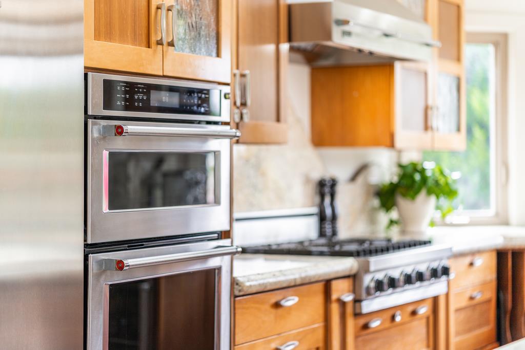 1501 Hidden Valley Road Soquel, CA 95073 - Photo 10 of 61 a kitchen with stainless steel appliances granite countertop a stove and a microwave
