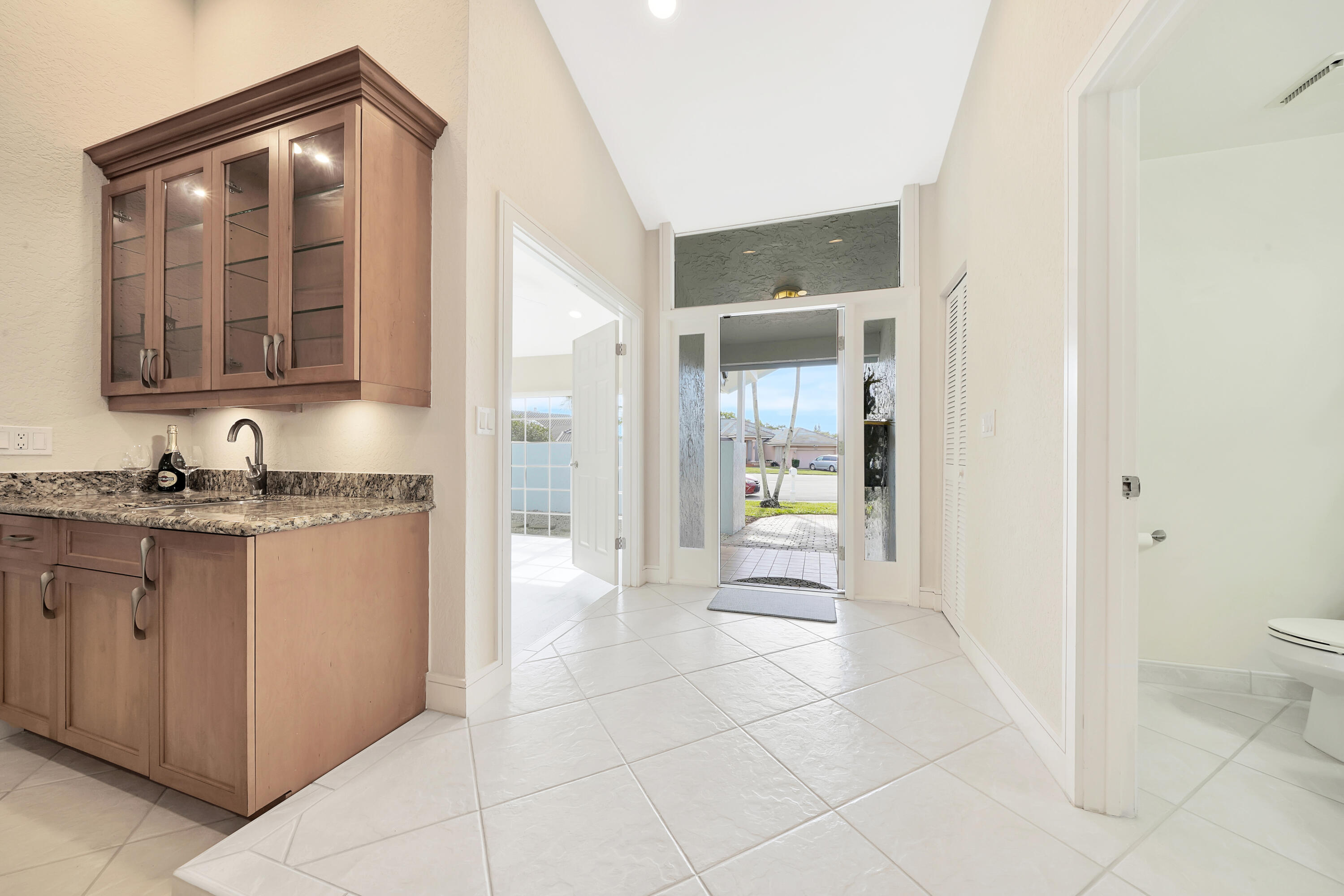 2475 Northwest 25th Street Boca Raton, FL 33431 - Photo 21 of 72 a bathroom with a granite countertop sink and a mirror