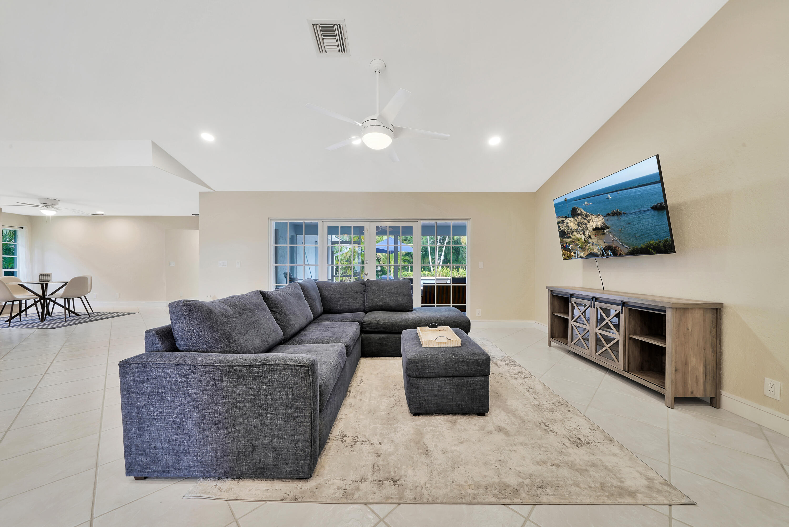2475 Northwest 25th Street Boca Raton, FL 33431 - Photo 27 of 72 a living room with furniture and a flat screen tv