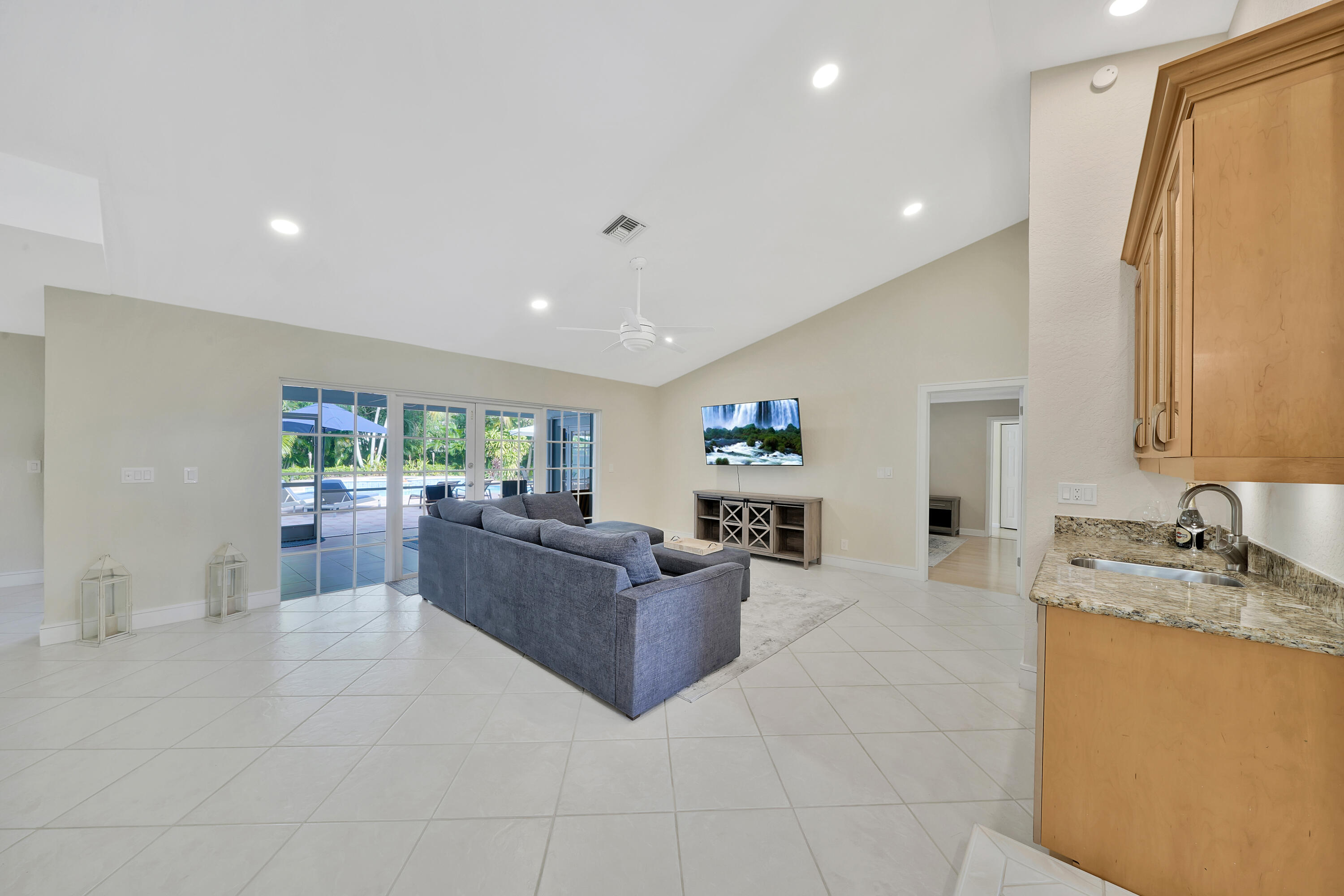 2475 Northwest 25th Street Boca Raton, FL 33431 - Photo 31 of 72 a living room with furniture and a flat screen tv