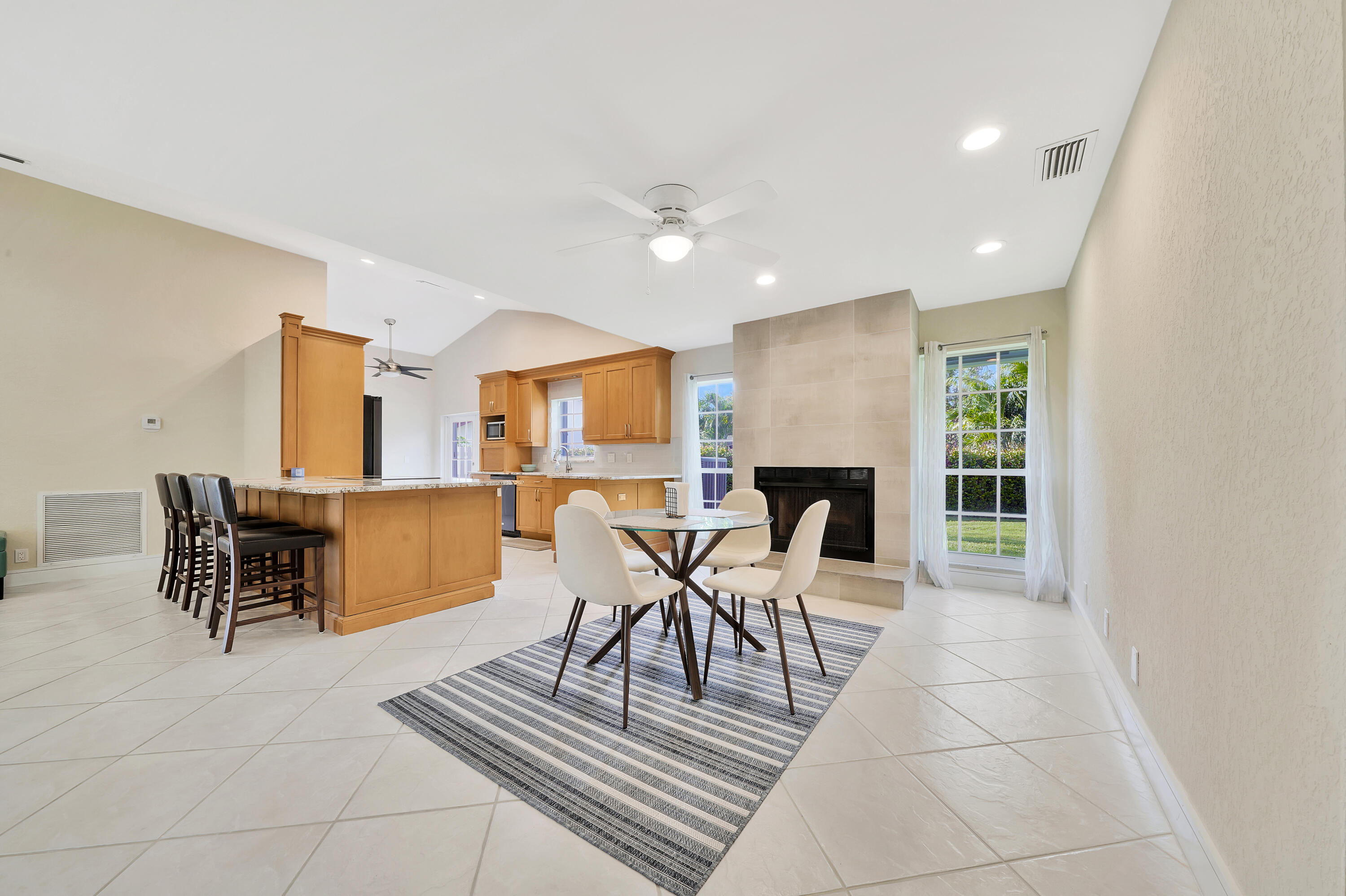 2475 Northwest 25th Street Boca Raton, FL 33431 - Photo 34 of 72 a living room with furniture a fireplace and a table