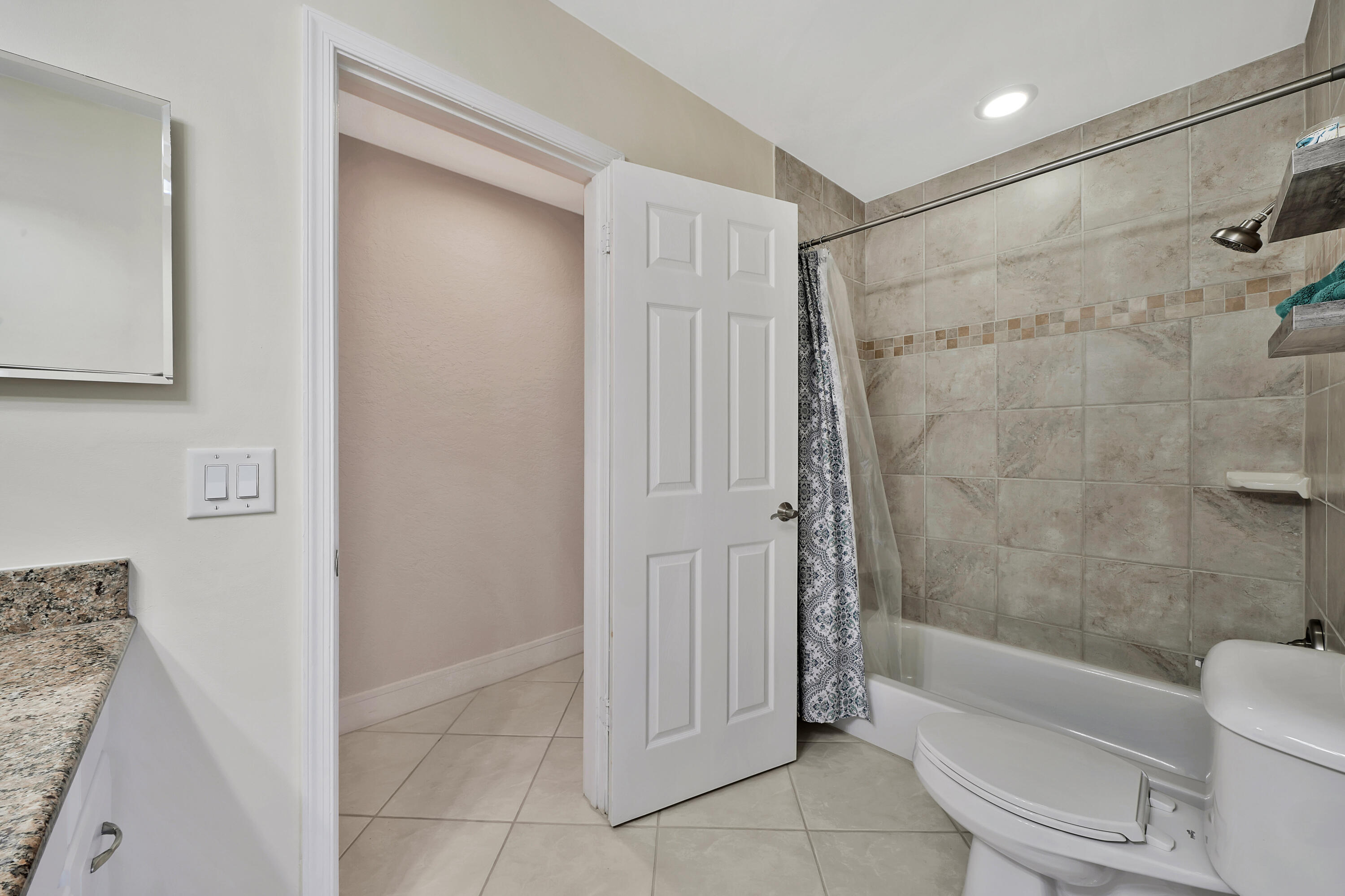 2475 Northwest 25th Street Boca Raton, FL 33431 - Photo 39 of 72 a bathroom with a shower a toilet and bathtub